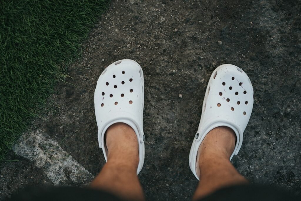 person wearing Crocs sandals indoors