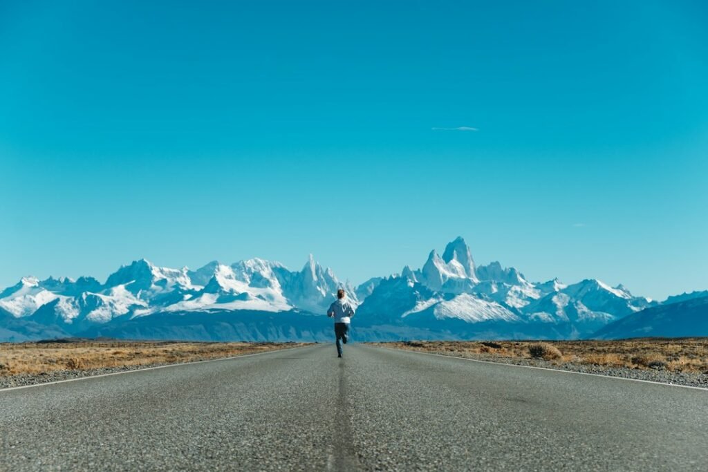 runner on a long road run at sunrise