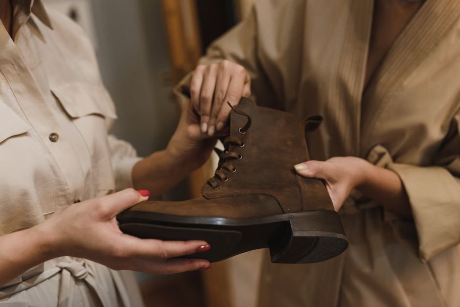 person inspecting a supportive walking shoe