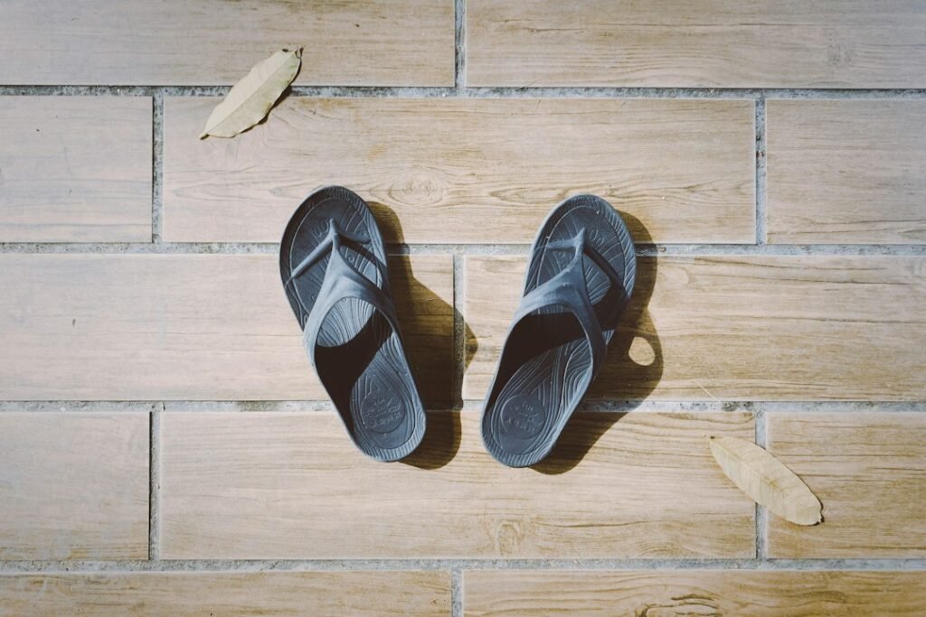 orthopedic arch support slippers on a hardwood floor