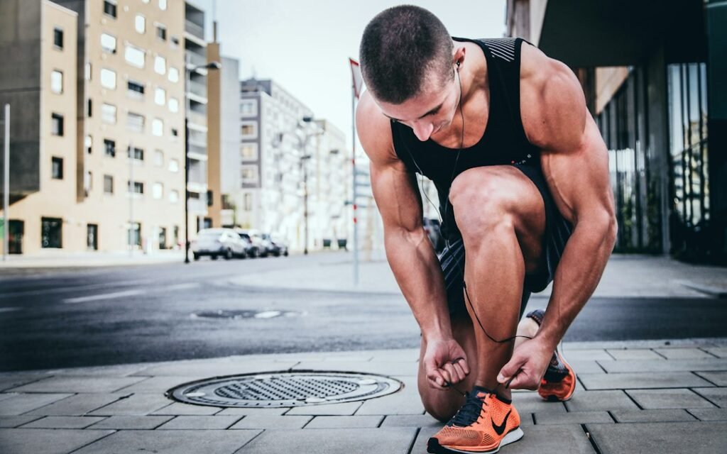 runner tying marathon running shoes