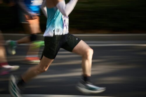 runner crossing a 10k road race finish line