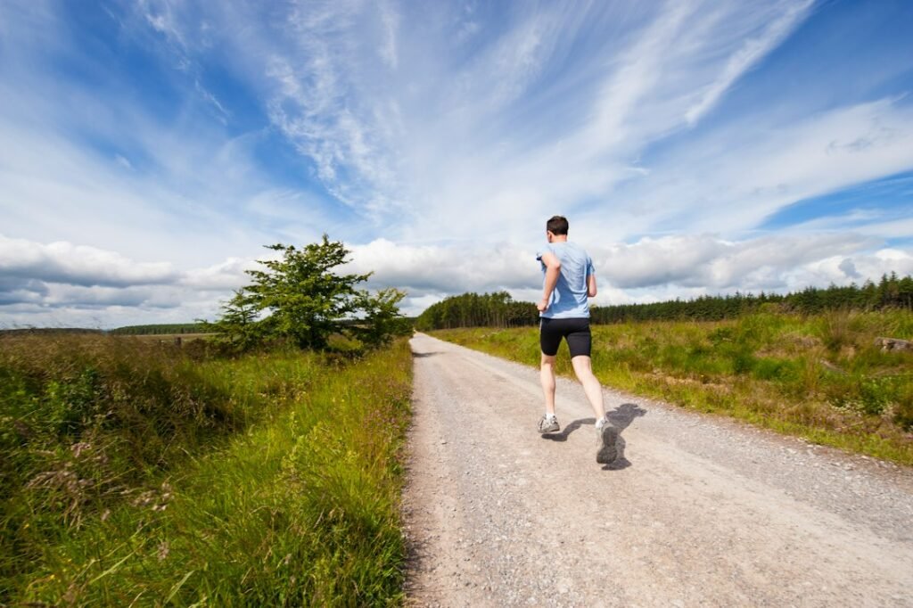 runner wearing wide toe box running shoes on a road